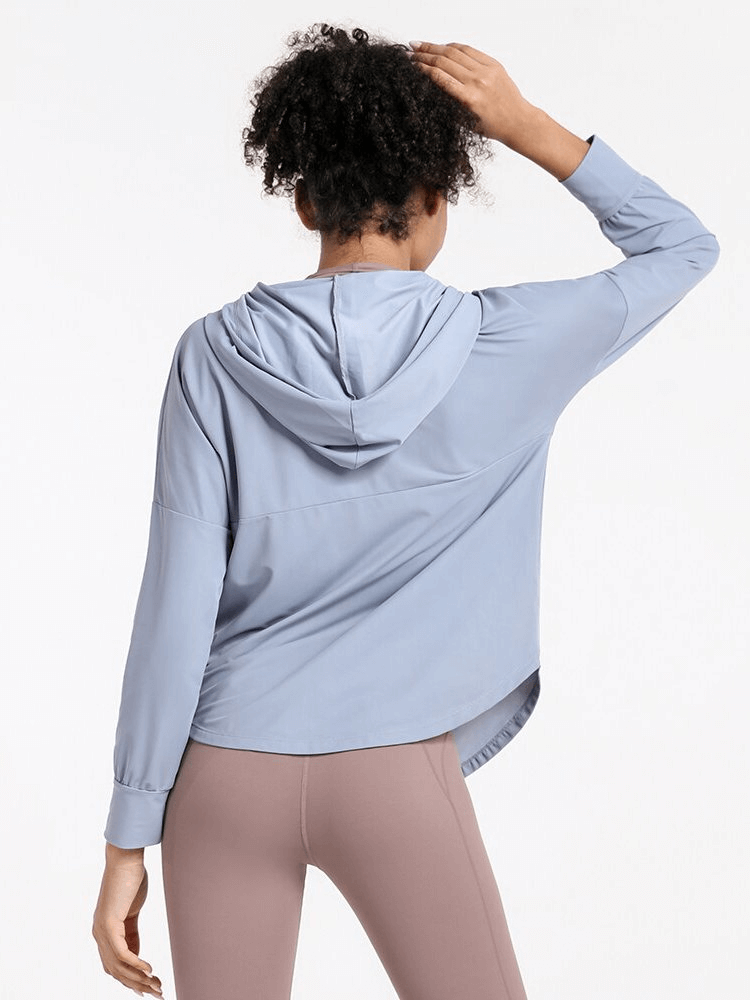 Woman wearing a light blue quick dry loose casual hoodie with zipper, perfect for yoga or running, showcasing breathable fabric.